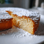 cloud cake topped with powdered sugar on a white plate