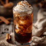 Cinnamon roll dirty soda with creamy swirls and whipped topping